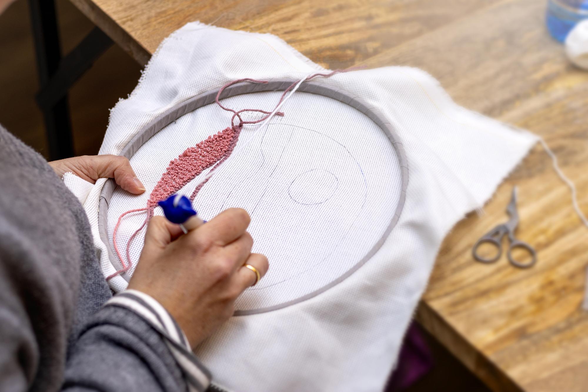 artisan hands hooping cloth for embroidery